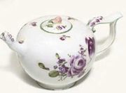 A GERMAN PORCELAIN BULLET-SHAPED TEAPOT AND COVER