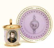 A SEVRES (HARD PASTE) PINK GROUND IMPERIAL PORTRAIT CUP AND SAUCER